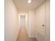 Hallway with carpet and neutral walls, showcasing storage space and access to other rooms at 16301 Sanctuary Reserve Loop, Clermont, FL 34714