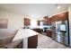 Contemporary kitchen with breakfast bar, stainless steel appliances, and stylish dark-stained cabinetry at 16301 Sanctuary Reserve Loop, Clermont, FL 34714