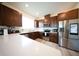 Gourmet kitchen featuring stainless steel appliances, white countertops and lots of dark wood cabinetry at 16301 Sanctuary Reserve Loop, Clermont, FL 34714