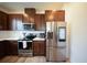 Modern kitchen features stainless steel appliances, ample cabinet space, and sleek countertops at 16301 Sanctuary Reserve Loop, Clermont, FL 34714