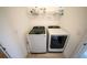 Modern laundry room with new Samsung washer and dryer and white wire shelving at 16301 Sanctuary Reserve Loop, Clermont, FL 34714