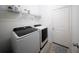 Bright laundry room featuring a washer and dryer set with stylish wood-look flooring and a storage shelf at 16301 Sanctuary Reserve Loop, Clermont, FL 34714