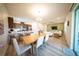 The open concept living area features a dining table, kitchen, and living room with modern finishes at 16301 Sanctuary Reserve Loop, Clermont, FL 34714