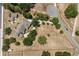 Aerial view of a well-maintained property featuring landscaping and multiple structures at 16500 Quarter Horse Ct, Montverde, FL 34756