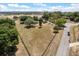 An aerial view of the property with trees surrounding a large grassy lot at 16500 Quarter Horse Ct, Montverde, FL 34756