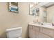Charming bathroom with seashell-decorated mirror and light-colored vanity at 16500 Quarter Horse Ct, Montverde, FL 34756