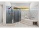 Spacious bathroom with walk-in shower, tiled walls, and separate soaking tub at 16500 Quarter Horse Ct, Montverde, FL 34756