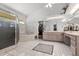 Expansive bathroom featuring tile floors, walk-in shower, and separate soaking tub at 16500 Quarter Horse Ct, Montverde, FL 34756