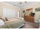 A cozy bedroom featuring a dresser with a mirror, and a standard closet at 16500 Quarter Horse Ct, Montverde, FL 34756