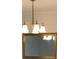 Close-up of a chandelier and a framed mirror at 16500 Quarter Horse Ct, Montverde, FL 34756