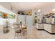 Bright dining area with a bay window, elegant decor, and an open layout leading into the kitchen at 16500 Quarter Horse Ct, Montverde, FL 34756