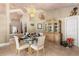 Sophisticated dining room with a glass-top table, elegant furnishings, and a decorative ceiling fan, perfect for gatherings at 16500 Quarter Horse Ct, Montverde, FL 34756
