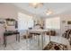 Bright dining room featuring tile flooring, three ceiling fans, a chandelier, and plenty of decor at 16500 Quarter Horse Ct, Montverde, FL 34756