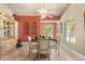 Charming dining room with a chandelier, arched windows, and a glass-top table set for four at 16500 Quarter Horse Ct, Montverde, FL 34756