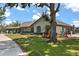 Well-maintained home with a long driveway, mature trees, showcasing curb appeal and charm at 16500 Quarter Horse Ct, Montverde, FL 34756