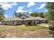 Stately home with a welcoming front porch and lush landscaping against a partly cloudy sky at 16500 Quarter Horse Ct, Montverde, FL 34756