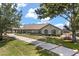 Well-maintained home with a long driveway, showcasing curb appeal and exterior charm at 16500 Quarter Horse Ct, Montverde, FL 34756