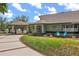 Home featuring a covered drive and manicured lawn, showcasing elegant curb appeal and outdoor charm at 16500 Quarter Horse Ct, Montverde, FL 34756