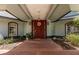 Front entry with a charming wooden door, brick pathway, and decorative plants at 16500 Quarter Horse Ct, Montverde, FL 34756