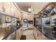 Well-equipped kitchen with stainless steel appliances, black countertops, and modern lighting at 16500 Quarter Horse Ct, Montverde, FL 34756