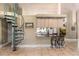 Kitchen area with a spiral staircase, bar-height seating, offering partial views of the main kitchen area at 16500 Quarter Horse Ct, Montverde, FL 34756