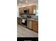 Kitchen with wood cabinets, stainless steel appliances, and tile backsplash at 16500 Quarter Horse Ct, Montverde, FL 34756