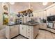 Well-equipped kitchen featuring stainless appliances, a pot rack, and an island for added workspace and storage at 16500 Quarter Horse Ct, Montverde, FL 34756
