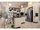 Spacious kitchen featuring a pot rack, stainless steel appliances, black counters, and ample storage space at 16500 Quarter Horse Ct, Montverde, FL 34756