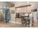 Kitchen area featuring a spiral staircase, bar-height seating with storage, and views of the main kitchen at 16500 Quarter Horse Ct, Montverde, FL 34756