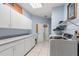 Well-organized laundry room with storage cabinets, counter space, and modern washer and dryer at 16500 Quarter Horse Ct, Montverde, FL 34756