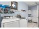 Functional laundry room featuring modern appliances, storage, a utility sink and stylish decor at 16500 Quarter Horse Ct, Montverde, FL 34756