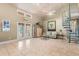 Spacious living room featuring tile floors, spiral staircase, and plenty of natural light at 16500 Quarter Horse Ct, Montverde, FL 34756