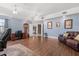 Spacious living room featuring hardwood floors, blue walls, and traditional decor at 16500 Quarter Horse Ct, Montverde, FL 34756