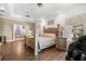 Bright bedroom with decorative tray ceiling, wood floors, and ensuite bathroom at 16500 Quarter Horse Ct, Montverde, FL 34756