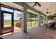 The covered brick porch has seating and ceiling fans at 16500 Quarter Horse Ct, Montverde, FL 34756