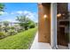 Exterior view of the backyard with lush green grass and a pond, as seen from the patio at 1821 San Jacinto Cir, Sanford, FL 32771