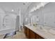 Bright bathroom featuring double sinks, vanity cabinets, a walk-in shower, and a tub at 1821 San Jacinto Cir, Sanford, FL 32771