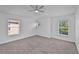 Spacious bedroom featuring neutral carpeting, a ceiling fan, and natural light at 1821 San Jacinto Cir, Sanford, FL 32771