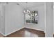 Bright dining room with hardwood floors, a window, and modern chandelier lighting at 1821 San Jacinto Cir, Sanford, FL 32771
