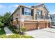 Two-story townhome with a two-car garage, balcony, and well-maintained landscaping at 1821 San Jacinto Cir, Sanford, FL 32771