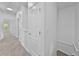 Bright hallway featuring carpet, multiple doors and access to stairs at 1821 San Jacinto Cir, Sanford, FL 32771