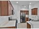 Stylish kitchen featuring dark cabinets, stainless steel appliances, and white countertops at 1821 San Jacinto Cir, Sanford, FL 32771