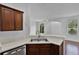 A kitchen sink with dark cabinets, stainless steel appliances, and white countertops at 1821 San Jacinto Cir, Sanford, FL 32771