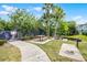 Community picnic area with tables, BBQ grills, and shady trees for outdoor enjoyment at 1821 San Jacinto Cir, Sanford, FL 32771