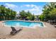Community pool with ample lounge chairs and a brick-paved deck for relaxing and sunbathing at 1821 San Jacinto Cir, Sanford, FL 32771