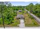 A charming single story house is set amidst verdant trees and landscaped lawn at 1898 9Th Ave, Deland, FL 32724