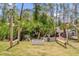 Private backyard oasis with rustic outdoor seating, lush greenery, and a relaxed atmosphere at 1898 9Th Ave, Deland, FL 32724