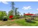 Lush backyard with various seating areas, grilling station, and ample space for outdoor activities at 1898 9Th Ave, Deland, FL 32724