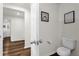 Neat bathroom features a toilet, clean floors, and a hallway view at 1898 9Th Ave, Deland, FL 32724