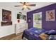 Well-lit sports-themed bedroom with hardwood floors, ceiling fan, and decorative sports memorabilia at 1898 9Th Ave, Deland, FL 32724